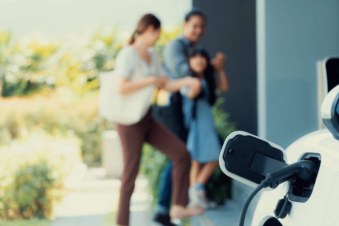 Focus home charging station for EV car, blur progressive family in background. smart vending route optimization
